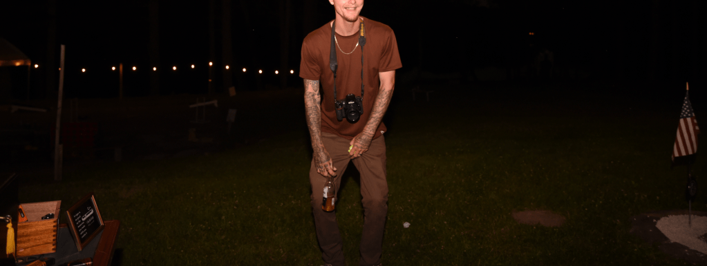 Photographer's husband enjoying a beer and vape during client's wedding on June 15, 2024, in East Brunswick, NJ.